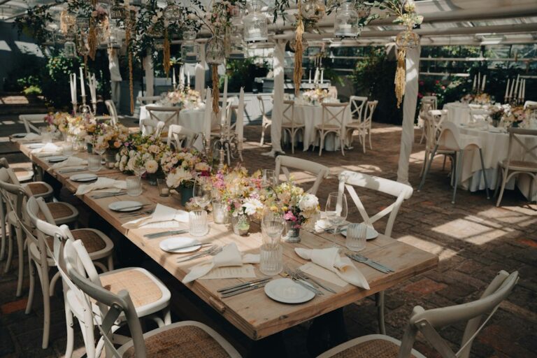 Guests walk between ceremony chairs and a reception dining area in a thoughtfully arranged wedding venue.