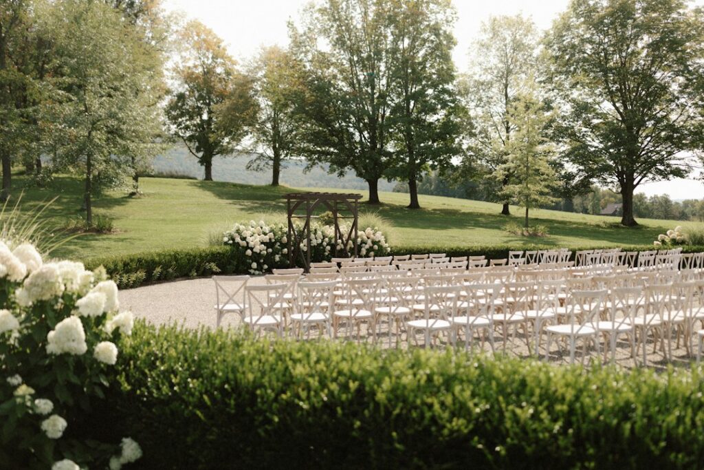 Wedding guests seated at reception tables beside a dance floor in a comfortable, well-lit venue.